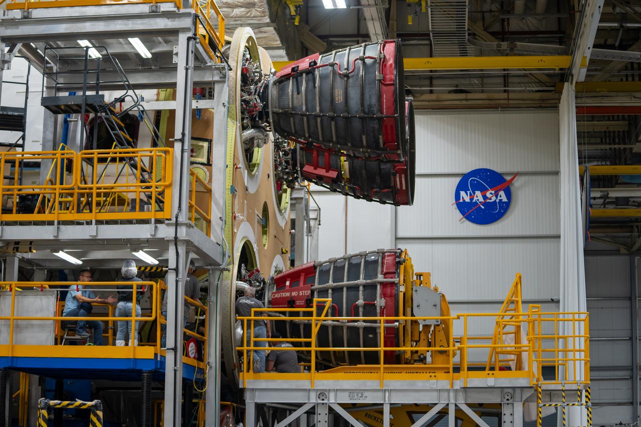 These photos and videos show how technicians at NASA’s Michoud Assembly Facility in New Orleans installed the third and fourth RS-25 engines onto the core stage for the agency’s SLS (Space Launch System) rocket that will help power NASA’s first crewed Artemis mission to the Moon.   Technicians added the first engine to the SLS core stage Sept. 11. The second engine was installed onto the stage Sept. 15 with the third and fourth engines following Sept. 19 and Sept. 20. Engineers consider the engines to be “soft” mated to the rocket stage. Technicians with NASA, Aerojet Rocketdyne, an L3Harris Technologies company and the RS-25 engines lead contractor, along with Boeing, the core stage lead contractor, will now focus efforts on the complex tax of fully securing the engines to the stage and integrating the propulsion and electrical systems within the structure.  NASA is working to land the first woman and first person of color on the Moon under Artemis. SLS is part of NASA’s backbone for deep space exploration, along with Orion and the Gateway in orbit around the Moon. SLS is the only rocket that can send Orion, astronauts, and supplies to the Moon in a single mission.
